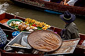 Thailand, Locals sell fruits, food and products at Damnoen Saduak floating market near Bangkok 